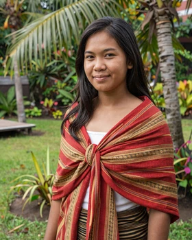 Beautiful Timorese woman wearing traditional tais cloth in tropical garden setting